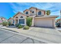 Charming two-story home featuring desert landscaping, a 2-car garage, and multiple arched windows at 18807 N 42Nd Ave, Glendale, AZ 85308