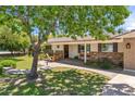 Welcoming home featuring a covered front porch with stone accents and a seating area at 2013 E Solano Dr, Phoenix, AZ 85016