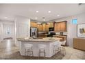 Spacious kitchen with granite countertops, wood cabinets, and a breakfast bar with seating for four at 20160 N Riverbank Rd, Maricopa, AZ 85138