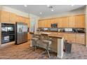 Well-equipped kitchen featuring stainless steel appliances, tile floors, a breakfast bar, and ample cabinet space at 2222 W Morse Ct, Anthem, AZ 85086