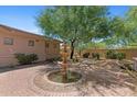 Landscaped backyard featuring a water fountain surrounded by trees and green foliage at 22463 N 54Th St, Phoenix, AZ 85054