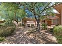 Exterior view of the house with mature landscaping, trees, and a paver walkway at 22463 N 54Th St, Phoenix, AZ 85054