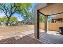 Spacious back patio, partially covered with brick pavers and stone, and views of mature trees for relaxation and entertainment at 2250 E Deer Valley Rd # 24, Phoenix, AZ 85024