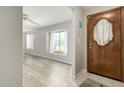 Inviting entryway features wood-look flooring, a decorative front door, and large window at 2259 E Ivy St, Mesa, AZ 85213