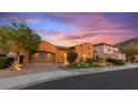 Charming single-story home featuring a well-maintained lawn, desert landscaping, and two car garage at 25943 N 84Th Dr, Peoria, AZ 85383