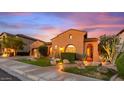 Charming single-story home featuring a well-maintained lawn, desert landscaping, and two car garage at 25943 N 84Th Dr, Peoria, AZ 85383