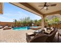 Inviting backyard pool and spa with covered patio and mountain views, perfect for relaxation and entertaining at 25943 N 84Th Dr, Peoria, AZ 85383