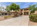 Spacious two-story home featuring a long driveway, three-car garage, and desert landscaping at 3133 N Medallion Ct, Casa Grande, AZ 85122