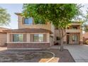 Charming two-story home featuring stucco siding, shutters, and a well-maintained front yard at 3133 N Medallion Ct, Casa Grande, AZ 85122
