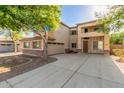 Charming two-story home featuring stucco siding, shutters, and a well-maintained front yard at 3133 N Medallion Ct, Casa Grande, AZ 85122