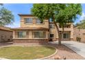 Charming two-story home with desert landscaping, brick accents, and light tan stucco at 3133 N Medallion Ct, Casa Grande, AZ 85122