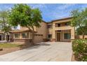 Inviting two-story home showcasing neutral stucco, brick accents, and a well-maintained lawn at 3133 N Medallion Ct, Casa Grande, AZ 85122