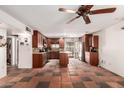 Spacious kitchen featuring ample wood cabinetry, a center island, and classic tile flooring at 355 E Fillmore St, Tempe, AZ 85288