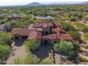 Expansive estate with a red tile roof, desert landscaping, and a three-car garage in a private community at 37440 N 104Th Pl, Scottsdale, AZ 85262