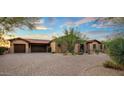 Beautiful house with a desert landscape, brick driveway, and a spacious three-car garage at 37440 N 104Th Pl, Scottsdale, AZ 85262