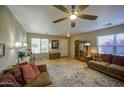 Inviting living room with a ceiling fan, natural light, wood floors, and comfortable furnishings at 3790 W White Canyon Rd, San Tan Valley, AZ 85144