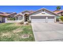 Charming single-story home with a well-maintained front yard and three-car garage, perfect for a Gathering at 3834 E Windsong Dr, Phoenix, AZ 85048