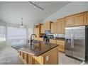 Modern kitchen features stainless steel appliances, granite countertops, and an island with sink, ideal for cooking at 3834 E Windsong Dr, Phoenix, AZ 85048