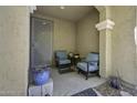 Cozy front porch featuring comfortable seating and decorative potted plants for relaxing outdoors at 40893 W Bedford Dr, Maricopa, AZ 85138