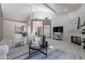 Spacious living area with a fireplace and views to the dining room and front entry at 4116 E Sunnyside Dr, Phoenix, AZ 85028