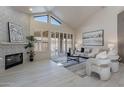 Beautifully lit living room features a fireplace, large painting, and modern furniture on a gray rug at 4116 E Sunnyside Dr, Phoenix, AZ 85028