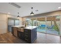 Modern kitchen with a large island, stainless steel appliances, and a view of the outdoor patio at 4248 N Parkway Ave, Scottsdale, AZ 85251
