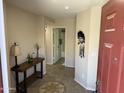 Inviting entryway with tile flooring, console table, and views leading into a bathroom and additional rooms at 42775 W Jeremy St, Maricopa, AZ 85138
