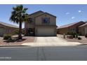 Inviting two-story home featuring a two-car garage, desert landscaping, and a mature palm tree in the front yard at 42775 W Jeremy St, Maricopa, AZ 85138