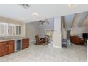 Bright, open-concept featuring a dining area and kitchen with wood cabinets and granite countertops at 4317 E Glenrosa Ave, Phoenix, AZ 85018