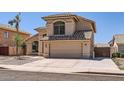 Attractive exterior of home with two-car garage, showcasing desert landscaping and tiled roof at 7239 E Madero Ave, Mesa, AZ 85209