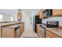 Functional kitchen with stainless appliances, ample cabinet storage, and easy access to the dining area at 7318 W St Charles Ave, Laveen, AZ 85339