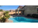 Relax by the pool in a private backyard with a covered patio and block wall at 7318 W St Charles Ave, Laveen, AZ 85339