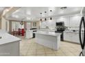 A bright kitchen features white cabinets, granite countertops, and stainless steel appliances at 7340 W Bronco Trl, Peoria, AZ 85383