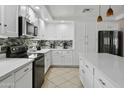 A bright kitchen features white cabinets, granite countertops, and stainless steel appliances at 7340 W Bronco Trl, Peoria, AZ 85383