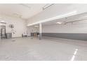 Spacious garage with epoxy flooring, tall ceilings, ample storage space, and utility sink at 8010 W Atlantis Way, Phoenix, AZ 85043