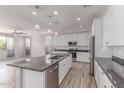 Bright kitchen featuring stainless steel appliances, a large island, pendant lighting, and wood-look floors at 8010 W Atlantis Way, Phoenix, AZ 85043