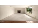 Spacious living room featuring a fireplace and large window offering plenty of natural light at 8121 N 8Th Ave, Phoenix, AZ 85021