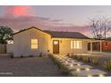 Exterior displaying walkway lighting, well-kept yard, and covered parking at 9042 N 3Rd Ave, Phoenix, AZ 85021
