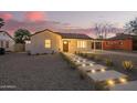 Charming house with walkway lighting, front yard landscaping, and white exterior paint at 9042 N 3Rd Ave, Phoenix, AZ 85021