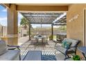 Cozy outdoor patio area with pergola, dining set, and comfortable seating at 913 W Leadwood Ave, Queen Creek, AZ 85140