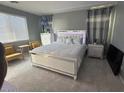 Relaxing bedroom with a large window, neutral decor, and an inviting bed at 9444 W Roma Ave, Phoenix, AZ 85037
