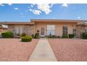 Inviting single-story house with a tidy front yard featuring desert landscaping and a clear pathway to the front door at 10161 W Thunderbird Blvd, Sun City, AZ 85351