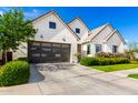 Contemporary home featuring a stylish garage door, concrete driveway, and tidy landscaping at 10206 E Texas Ave, Mesa, AZ 85212