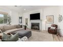 Comfortable living room features neutral colors, a gray fireplace, and lots of natural light at 10206 E Texas Ave, Mesa, AZ 85212