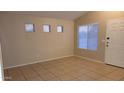 Bright, airy living room featuring neutral walls, tiled floors, and multiple windows with privacy blinds at 10645 W Piccadilly Rd, Avondale, AZ 85392