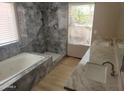 Beautiful bathroom featuring a soaking tub, dual sinks, and an elegant marble-tiled walk-in shower at 11889 N 113Th Pl, Scottsdale, AZ 85259