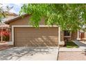 Charming single-story home featuring a well-maintained yard and a two-car garage at 12230 W Larkspur Rd, El Mirage, AZ 85335