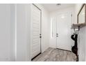 Bright foyer with wood-look tile flooring, a coat closet, and a front door with sidelight at 13228 W Buckskin Trl, Peoria, AZ 85383