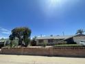Single-story home featuring desert landscaping and a decorative brick wall at 1529 W Eva St, Phoenix, AZ 85021
