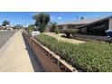 Single-story home with mature landscaping and decorative brick fencing at 1529 W Eva St, Phoenix, AZ 85021